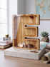 Personalized wood letter bank displayed with coins, showcasing a handcrafted heirloom piggy bank design.